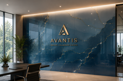 A modern office lobby with a large blue marble wall featuring the gold Avantis logo and name. A dark desk, black office chair, potted plants, and floor-to-ceiling windows are visible in the room.
