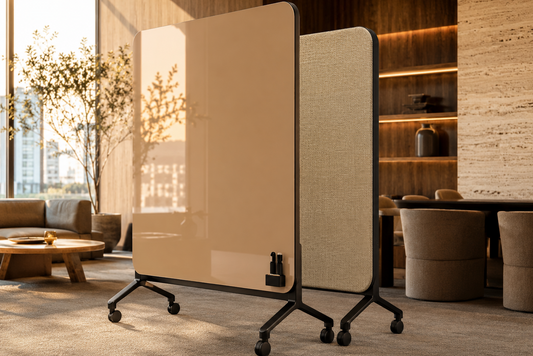 A modern rolling office partition screen with a glossy warm beige front panel and a textured beige fabric side panel, shown in a styled interior office setting.